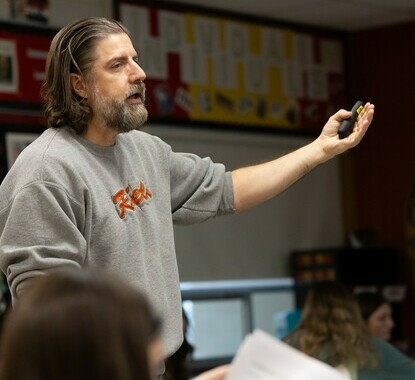 white man talking and using his hands to make a point